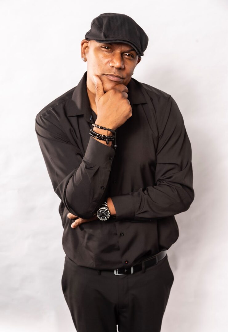 Man in black shirt, thoughtful pose.