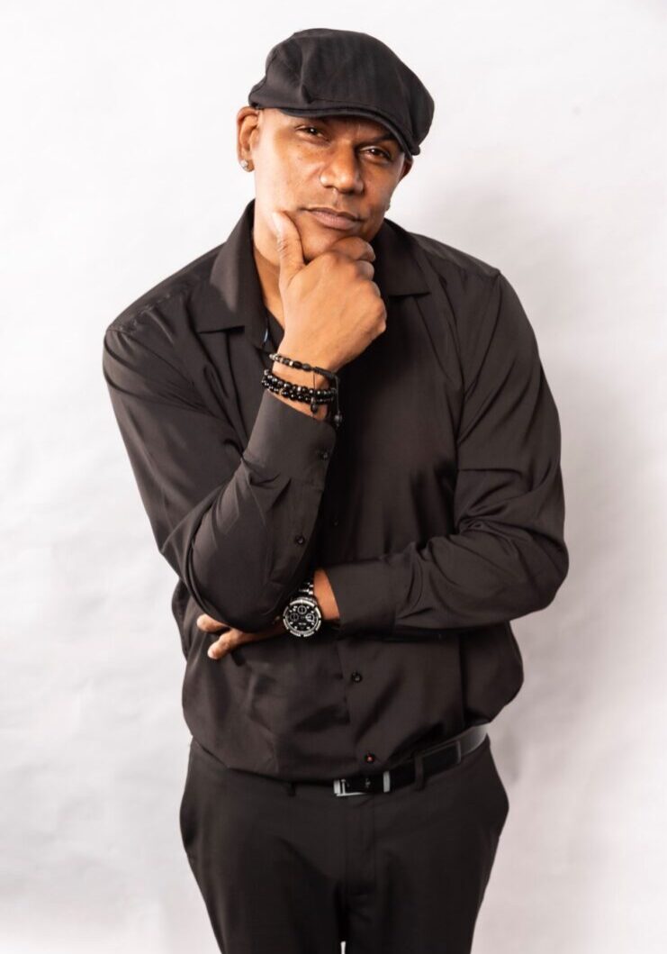 Man in black shirt, thoughtful pose.